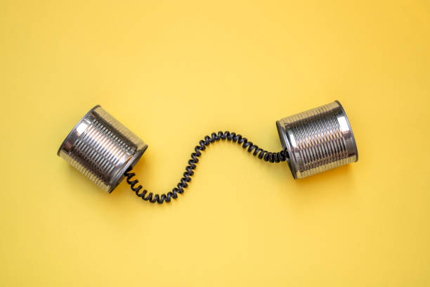 Tin can phone on yellow background, Communication concept Tin can phone on yellow background, Communication concept toy phone stock pictures, royalty-free photos & images