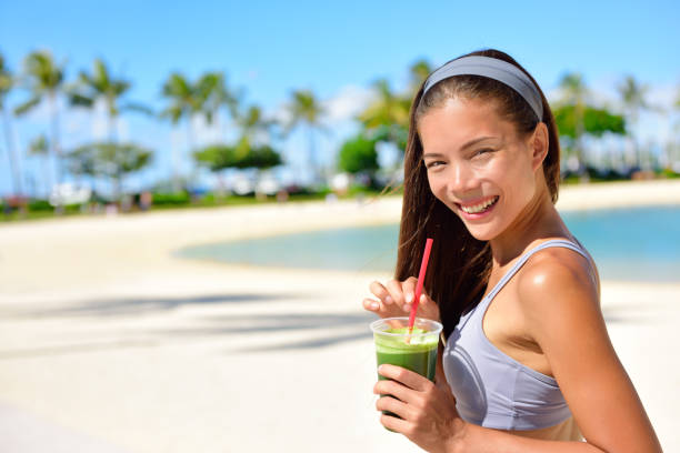 istock Green detox smoothie - woman drinking vegetables 1335912997