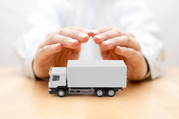 istock White cargo delivery truck protected by hands 1335913121