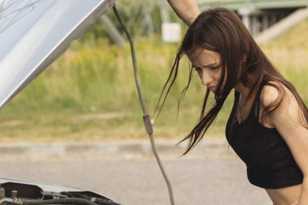 istock car breakdown,woman driver having trouble with her broken car 1335914706