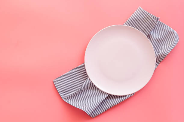 istock Top view of empty plate on napkin. Table setting for dinner 1335914990