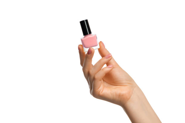Light pink nail polish in a beautiful female hand stock photo