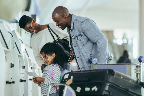 istock Family at airport checking boarding pass 1335918358
