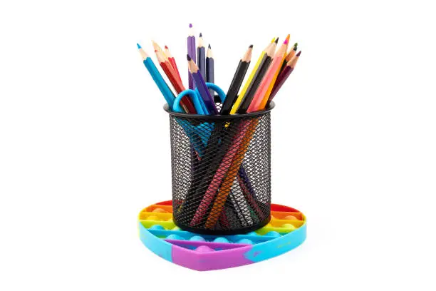 Photo of School supplies, children toy popit anti-stress on white background. Concept of the back to school.