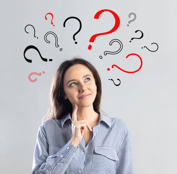 istock Question marks with young business woman 1335922321