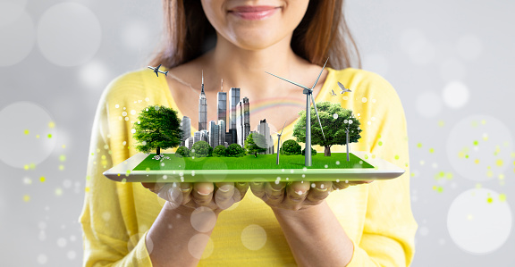 Young architect woman presenting virtual holographic nature friendly city project
