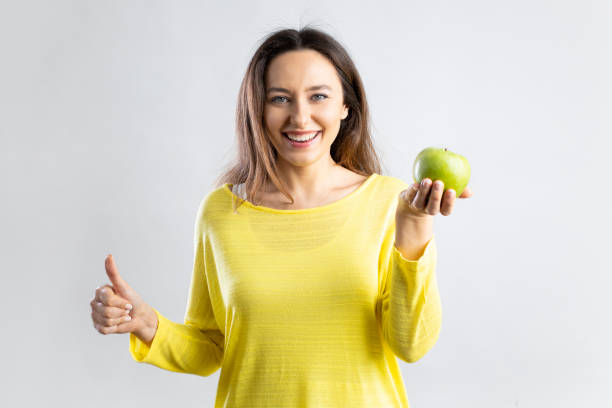 istock Smiling happy young holding an apple 1335922466