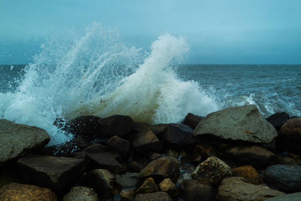 istock Splashing seawater to the broken jetty on the beach. Stormy waves eroding beaches on Cape Cod. 1335927271