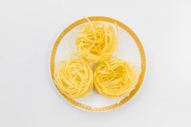 Raw pasta in a plate. Abstract culinary background with copy space