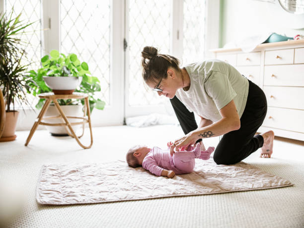 istock Young mother with baby at home 1335928372