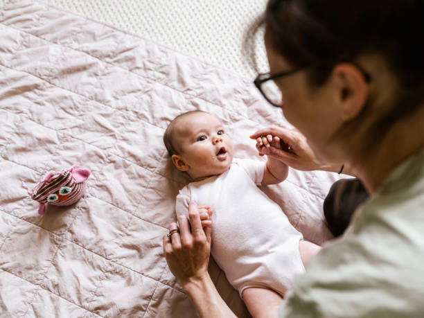 istock Young mother with baby at home 1335928482