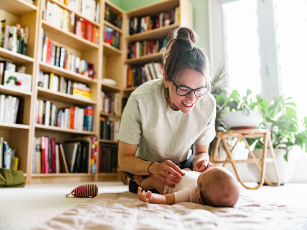 istock Young mother with baby at home 1335928518