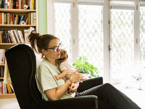 istock Young mother with baby at home 1335928589