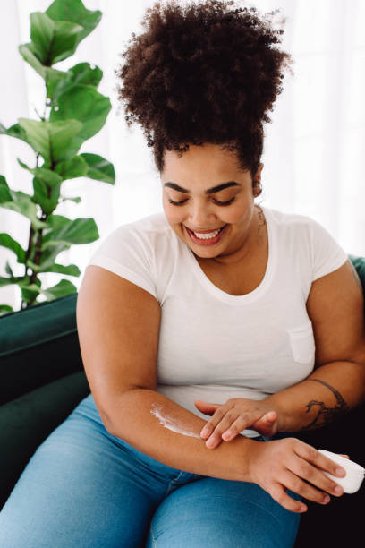 istock Beautiful female applying beauty cream on hand 1335930257