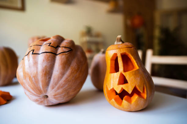 istock Carved pumpkins for Halloween on the table 1335930352