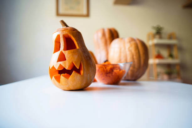 istock Carved pumpkins for Halloween on the table 1335930355