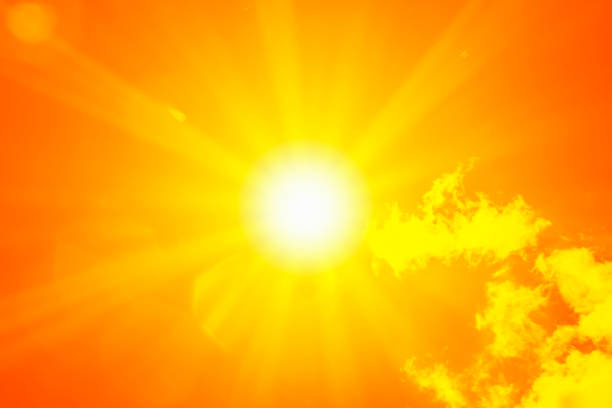 istock Bright sun with beautiful beams in the sky with clouds (toned in red) 1335932697