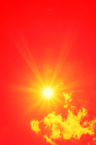 istock Bright sun with beautiful beams in the sky with clouds (toned in red) 1335932701