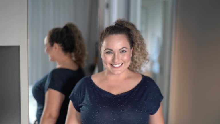 Portrait of a happy mid adult woman in front of mirror at home