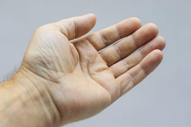 istock The outstretched hand of a man on a light background 1335936661