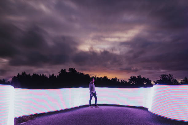 istock Woman looking at colorful night sky 1335936709