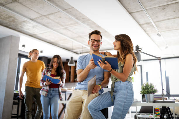 istock Group of happy young students having fun while studying together for exams 1335937035