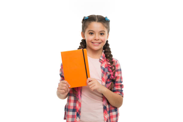 istock Child cute girl hold notepad or diary isolated on white background. Diary writing for children. Childhood memories. Diary for girls concept. Note secrets down in your cute girly diary journal 1335937290