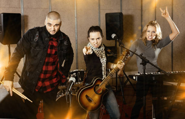 istock Three bandmates posing together with musical instruments in rehe 1335941024
