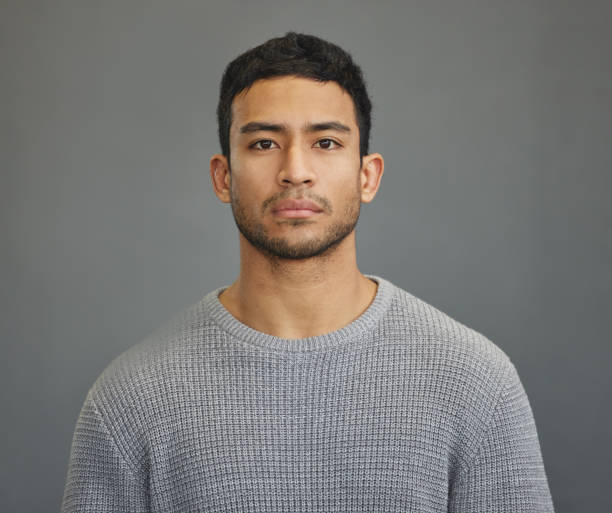 Shot of a handsome young man standing against a grey background