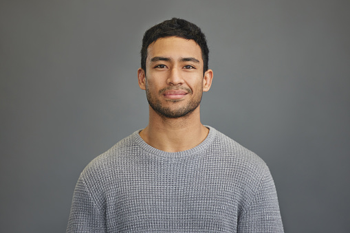 Shot of a handsome young man standing against a grey background