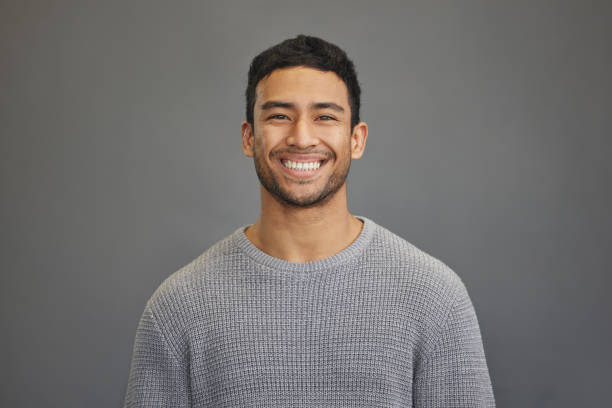 istock Shot of a handsome young man standing against a grey background 1335941249