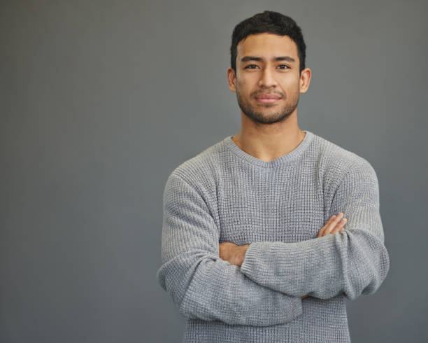 istock Shot of a handsome young man standing against a grey background 1335941250