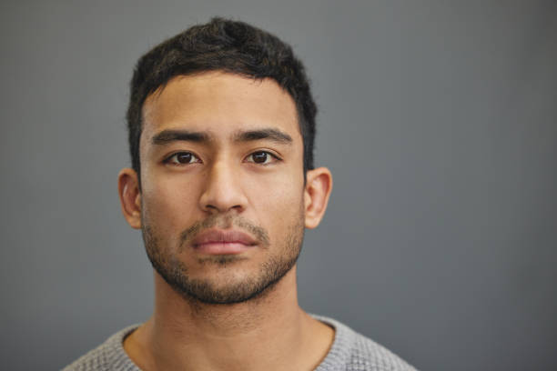istock Shot of a handsome young man standing against a grey background 1335941269