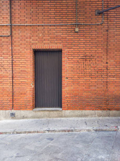 istock Metal door in a brick wall 1335950712