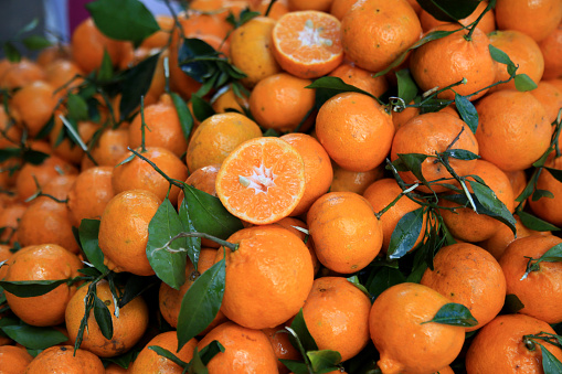 Fresh orange fruit on tree at orchard,Beautiful healthy juicy fruit growing in a sunny garden. Organic, healthy citrus outdoors. Athens, Greece. Copy space.on blurred background