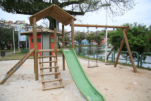 Empty round children's swing in the playground