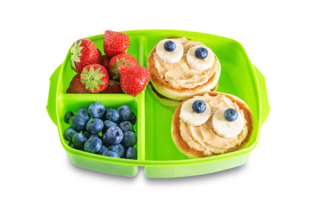 istock School healthy lunches with funny faces in a container on a white isolated background 1335958447