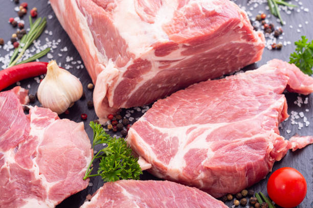 istock Raw pork neck with spices and herbs 1335960229