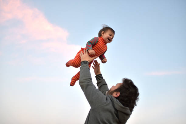 istock father playing with his son outdoors 1335962227
