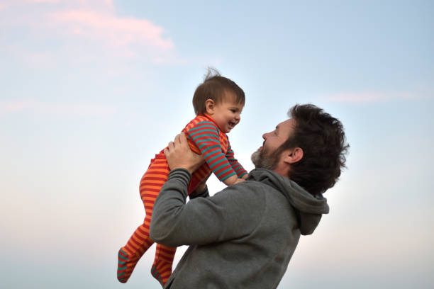 istock father playing with his son outdoors 1335962329