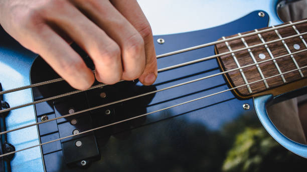 istock Defocused photo of playing bass guitar, practicing in open air 1335962476
