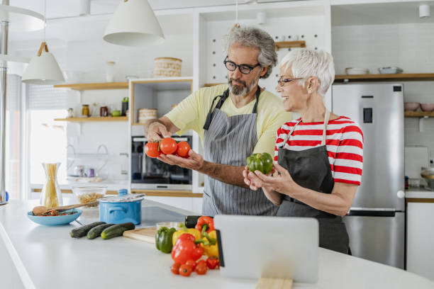 istock Senior couple cooking at home 1335964246