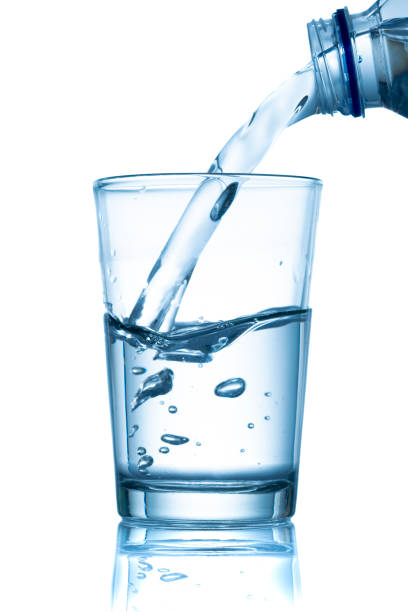 istock Glass of water and bottle on white 1335964484