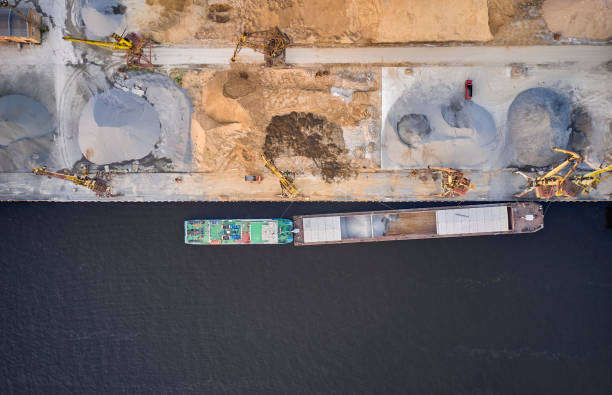 istock Top down aerial view of the river port and loading vessel 1335965742