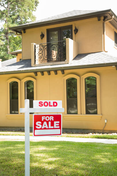 istock Beautiful home with a for sale sign in front yard. 1335968717