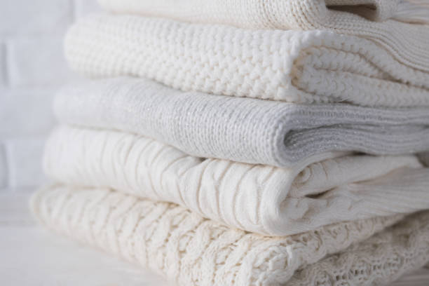 istock Warm cozy clothes with different knitted patterns close-up. Autumn or winter background. 1335970046