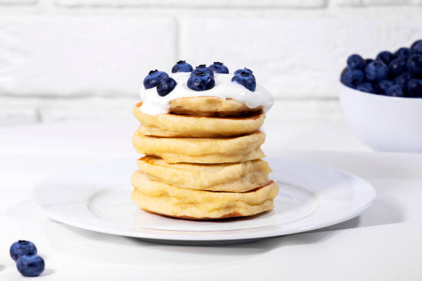istock Blueberry Pancakes With Yoghurt on white background, Traditional American Healthy Breakfast, Copyspace, Horizontal Resolution 1335972744