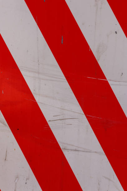 istock red and white diagonal stipes on flat steel sheet - caution road sign 1335973379