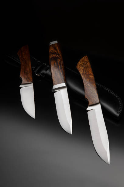 coltelli da caccia classici con manici in legno. caccia armi bordato su uno sfondo scuro. - blade steel shiny contemporary foto e immagini stock