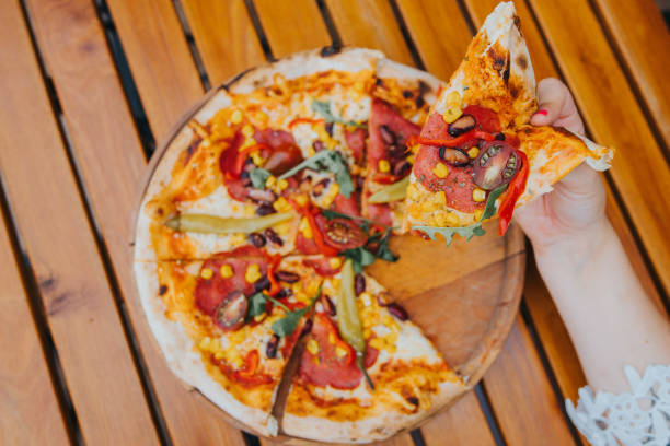 istock Girl taking one slice of pizza 1335975845